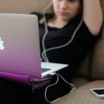 woman sitting on sofa with MacBook Air